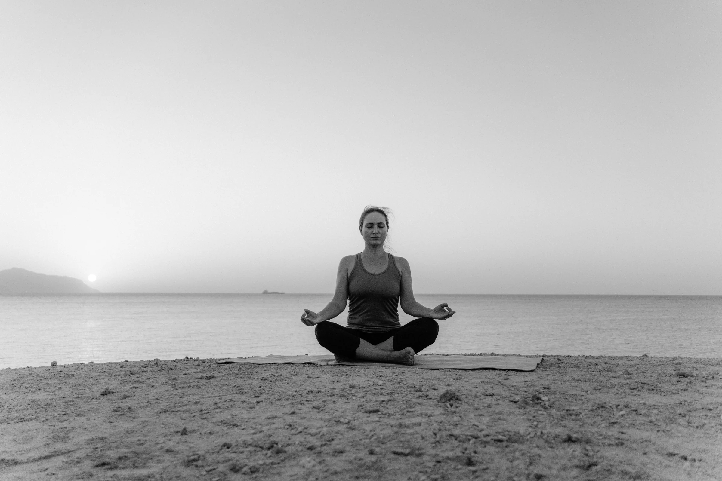 Yoga at the sandy Aegean beach at dusk.