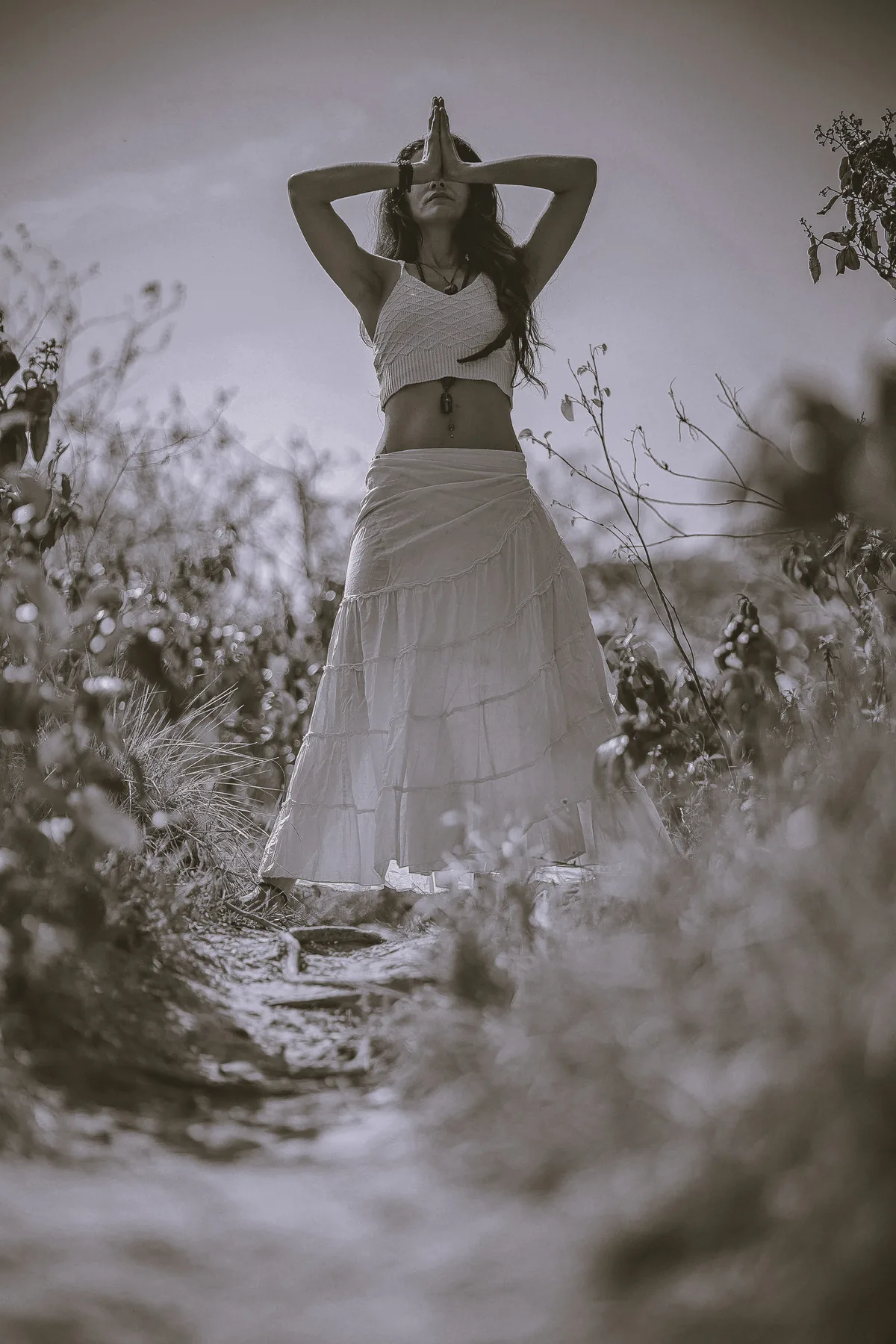 Woman in deep meditation, hands in prayer.